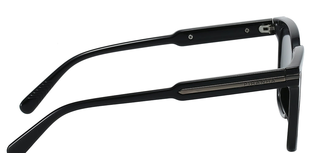 Right side facing view of a black square sunglasses frame with dark lenses, a molded plastic construction, and a lightweight design on a white background. Metal brads on outer corners for an attractive accent. Saddle bridge dips into flared nose pad as part of the frame. Ear tips gently curve behind the ear, metal accent on temple has PIRANHA san serif logo imprinted.