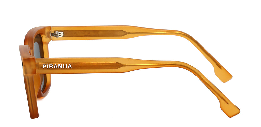 Left facing view of a vibrant orange frosted square sunglasses frame with dark gray polarized lenses.  Made of plastic with a slight frosted texture - made to be lightweight and comfortable. The temples have visible metal arms embedded in frosted orange plastic - with curved eartips flaring at tip in the shape of a square. Piranha san serif logo printed on right and left temples.